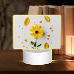 Rectangular Acrylic Night Light, A Yellow Flower With Yellow Petals And Green Leaves Is Placed On A White Surface.