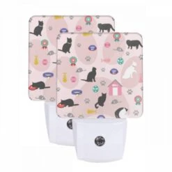 Night Light Set Of 2, A Cat Is Laying On A Pink Surface With A Cat House In The Background.