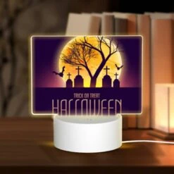 Rectangular Acrylic Night Light, A Halloween Poster With A Tree And Crosses.