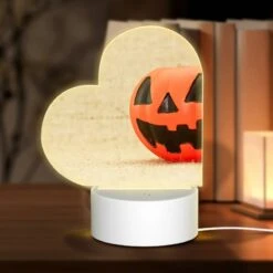 Love Acrylic Night Light, A Small Orange Pumpkin Sits On A Carpet.