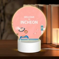 Round Acrylic Night Light, A Colorful Cartoon Of A Beach With A Ferris Wheel And A Sign That Says "Welcome To Incheon."