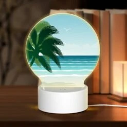 Round Acrylic Night Light, A Palm Tree Is On A Beach With A Blue Ocean In The Background.