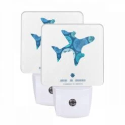 Night Light Set Of 2, A Blue And White Airplane With A Snowflake Pattern On The Tail.