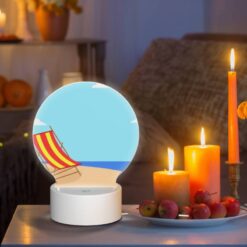 Round Acrylic Night Light, A Colorful Beach Chair Is Sitting On A Sandy Beach. -Nuas Diy Shop e190cfb0aeb85f44d397ae7d81fa34fe31e11ac6