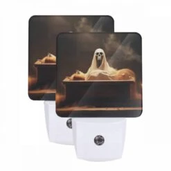 Night Light Set Of 2, A Skeleton Is Sitting On A Coffin With A Pumpkin On It.