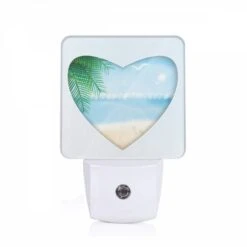 Night Light, A Heart Shaped Picture Of A Beach With A Bird Flying Over The Ocean.