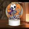 Round Acrylic Night Light, A Skeleton Is Sitting On A Pumpkin Patch With A Bat In The Background.