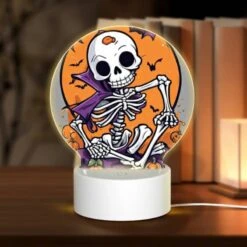 Round Acrylic Night Light, A Skeleton Is Sitting On A Pumpkin Patch With A Bat In The Background.