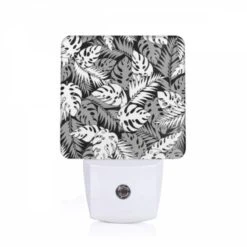 Night Light, A Black And White Image Of A Leafy Plant With A Pattern Of Dots.